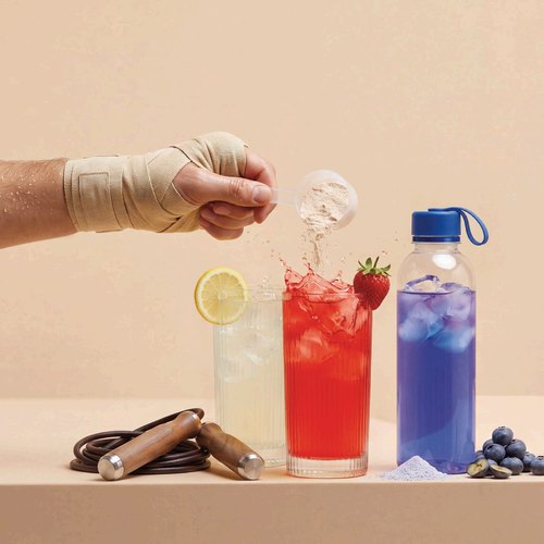 Ice dropped into lemon, strawberry and blueberry electrolyte drinks with a sports bottle
